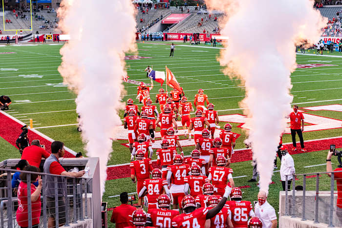 Houston football runs onto the field